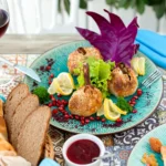 stuffed-dough-balls-with-sesame-sprinkles-served-with-lemon-slices